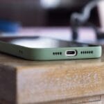 An iPhone on a wooden table displaying the battery charge socket